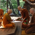 Sāmaṇera Guṇavīro offers Ajahn Karuṇadhammo a tray of offerings
