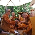 Sāmaṇera Tissaro offers Luang Por a tray of offerings
