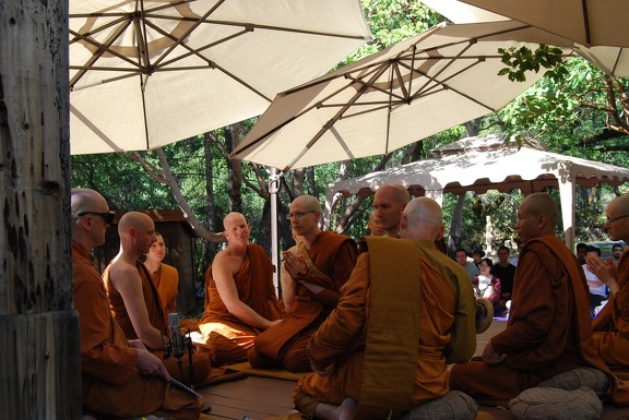 Sāmaṇeras Guṇavīro and Tissaro sit amidst the Sangha
