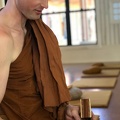 Ajahn Nyaniko offers a home-made sewing kit to the visiting monks