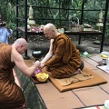 Ajahn Jayasaro paying respects to Luang Por Pasanno on his birthday outside of his cave retreat.