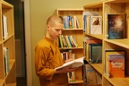 A monk peruses books in the library.