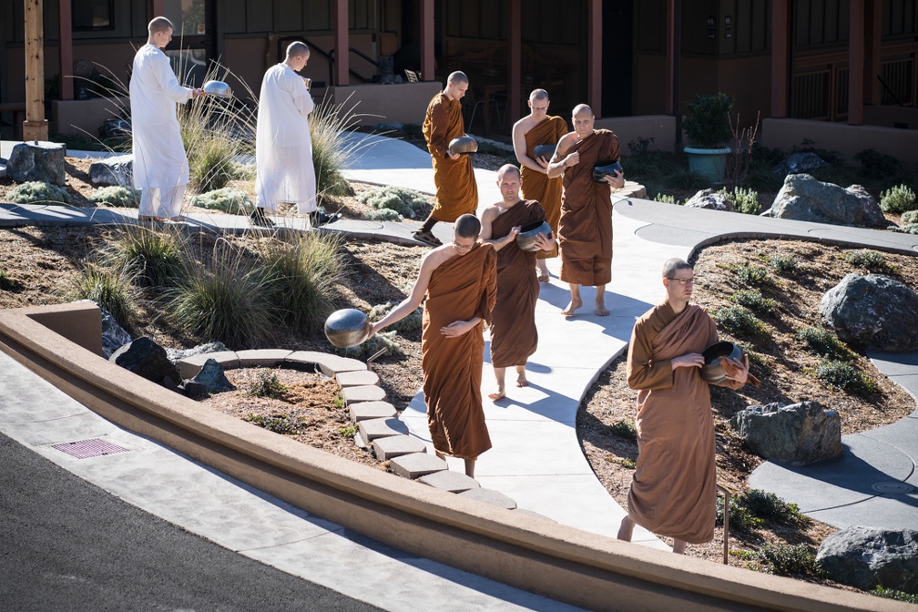 Monks walking to the meal during a rare, sunny day this winter.