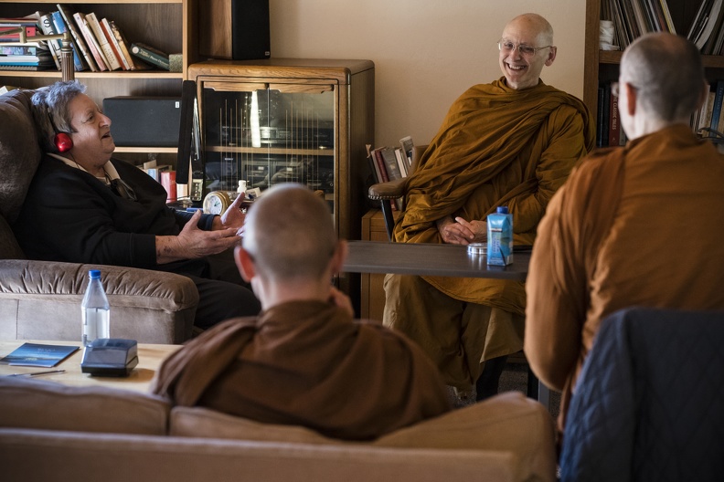 Mettika chats with monks at Three Jewels