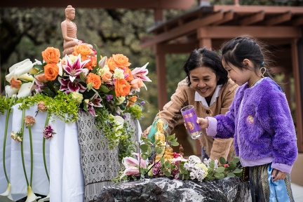 Lay guests shower the Buddha...