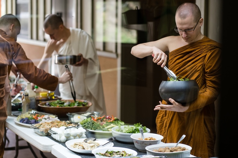 Monks select from the meal offerings.