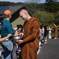 A monk collects alms from the Abhayagiri lay Sangha.