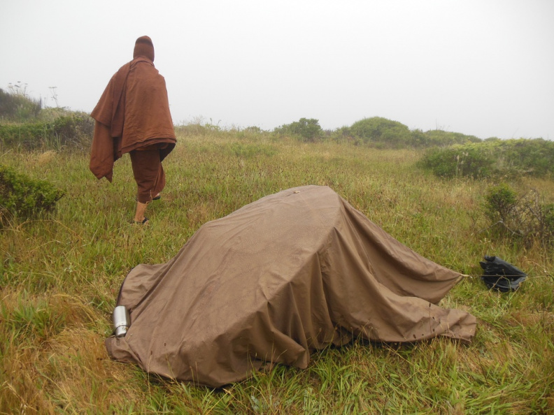 Morning dew covers Ajahn Sek's glot after a night on bluffs overlooking the Pacific