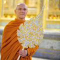 Luang Por holding his Chao Khun ceremonial fan