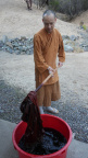 Ajahn Kassapo stirring the dye bath