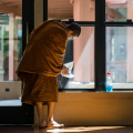 Bhikkhu Gunaviro cleans the Dhamma Hall before a full-moon lunar observance day in early April. 