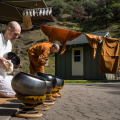 Anagarika Bret and Bhikkhu Jagaro drying meal bowls on a sunny afternoon in early-March. 