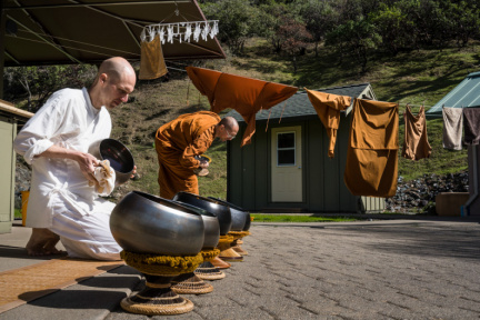 Anagarika Bret and Bhikkhu Jagaro drying meal bowls on a sunny afternoon in early-March. 