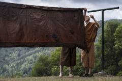 In a process developed at the time of the Buddha, a robe will be flipped in three steps so the natural dye settles evenly on the cloth. This rotation also prevents "racing stripes" as dye drips down the sides.