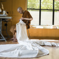 After daily chores and the midday meal, Dhammavaro sews his three robes. The “triple set”consists of the sabong - a robe worn at the waist; the jiworn - an outer robe covering the body; and the sanghati - a double-layered robe for formal occasions. 