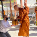Ajahn Karunadhammo hands his bowl to a visitor